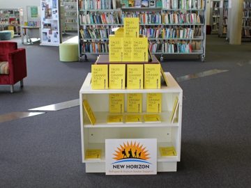 A display of yellow books in a library