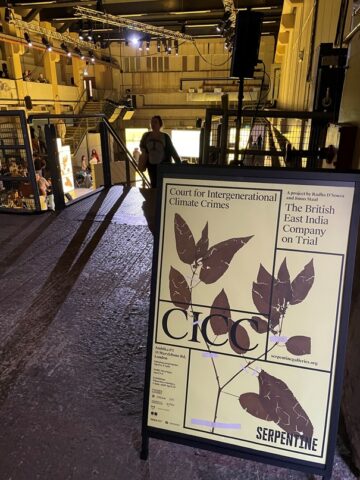A sandwich board/ sign at the entrance to the Court for Intergenerational Climate Crimes