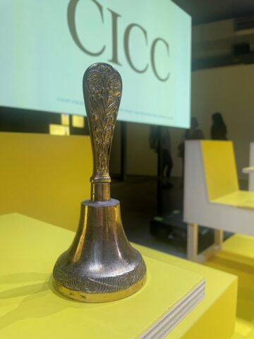 a bell on a yellow plinth on a yellow stage